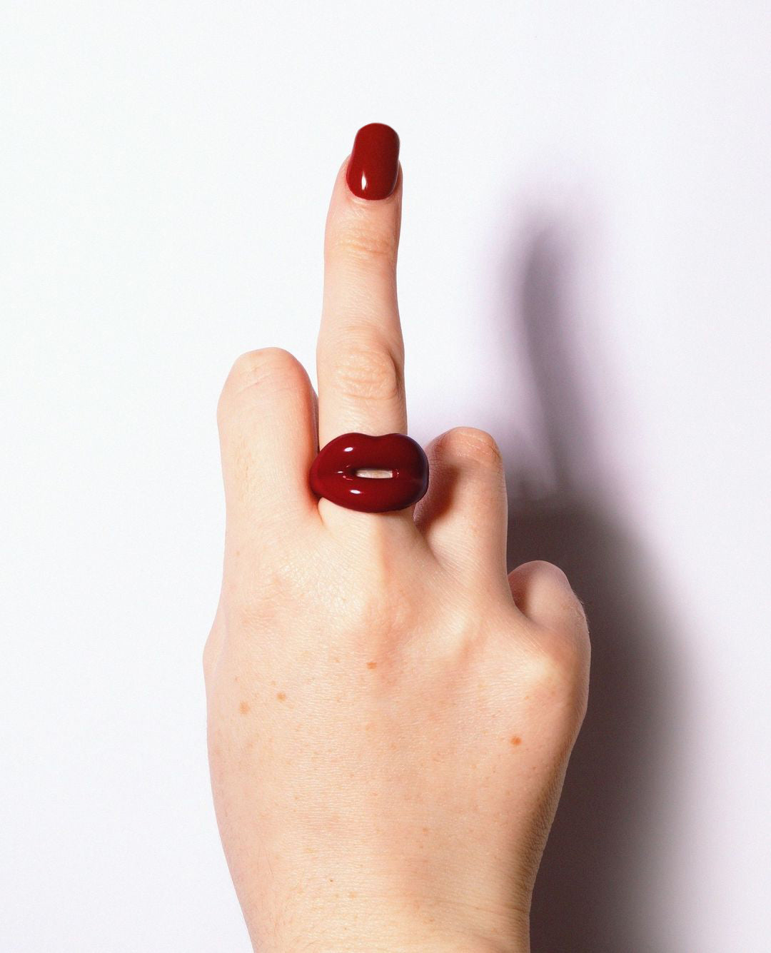 Hotlips by Solange Deep Red Silver and Enamel Lip Shaped Ring By Solange Azagury-Partridge On Models hand middle finger