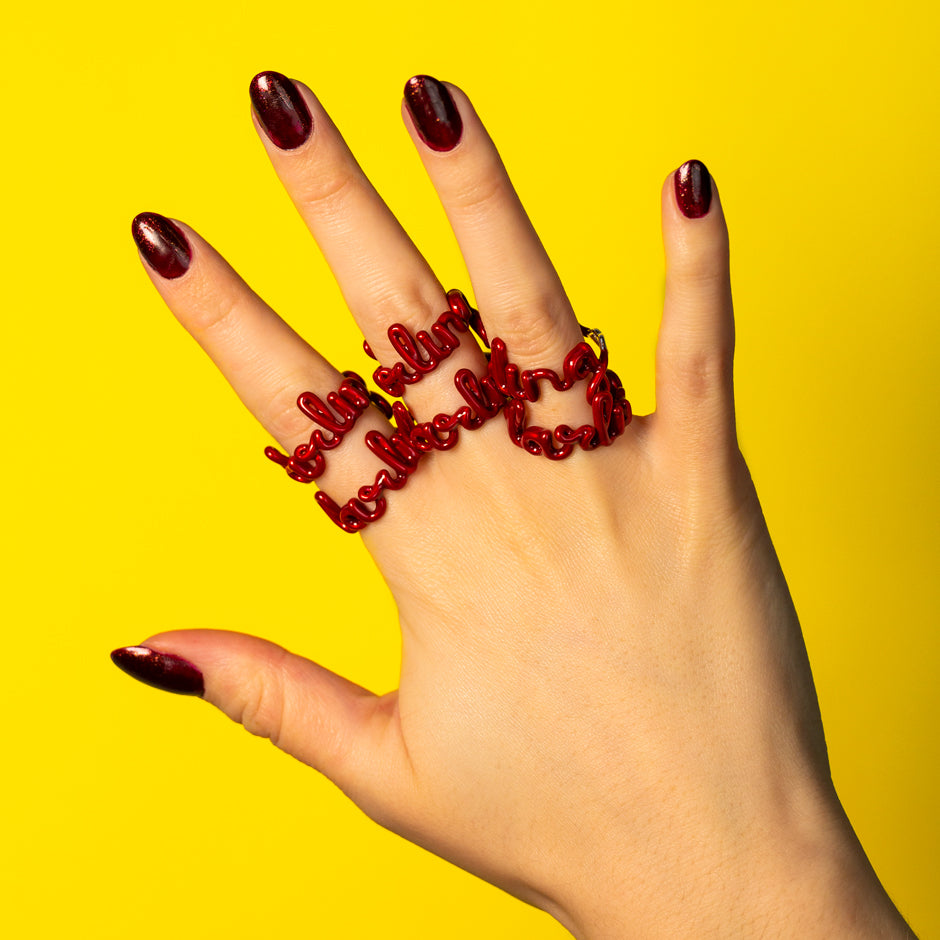 Darling multiple red enamel word Hotscripts ring on hand