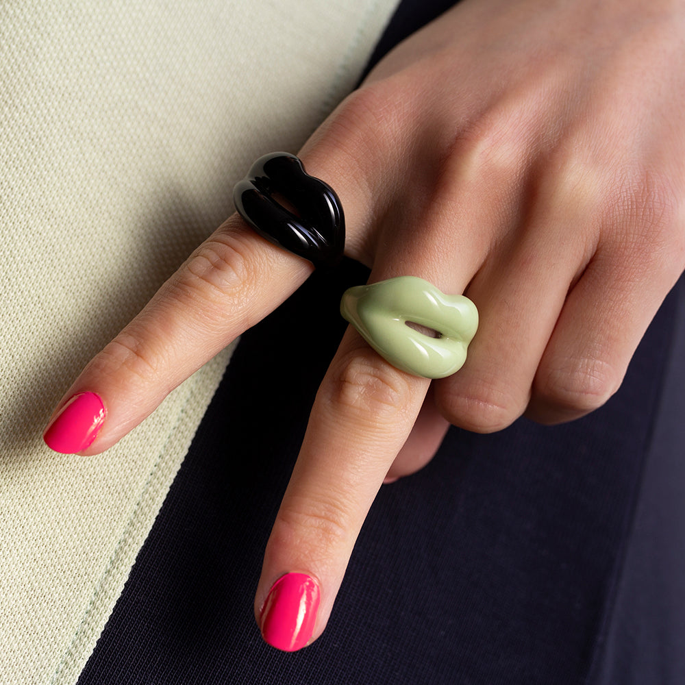 Black and glow in the dark hotlips ring on hand peace sign