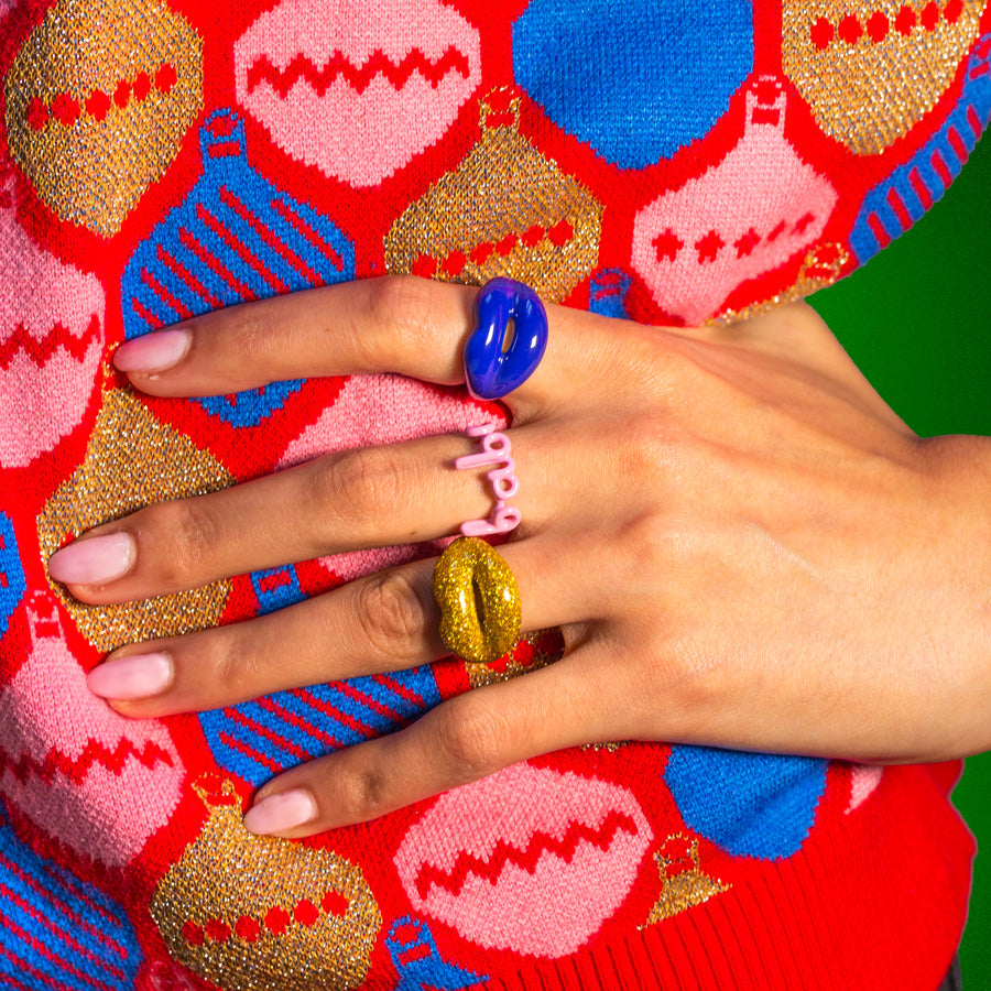 Glitter gold, babe, and royal blue Hotlips and Hotscript ring on Christmas Jumper