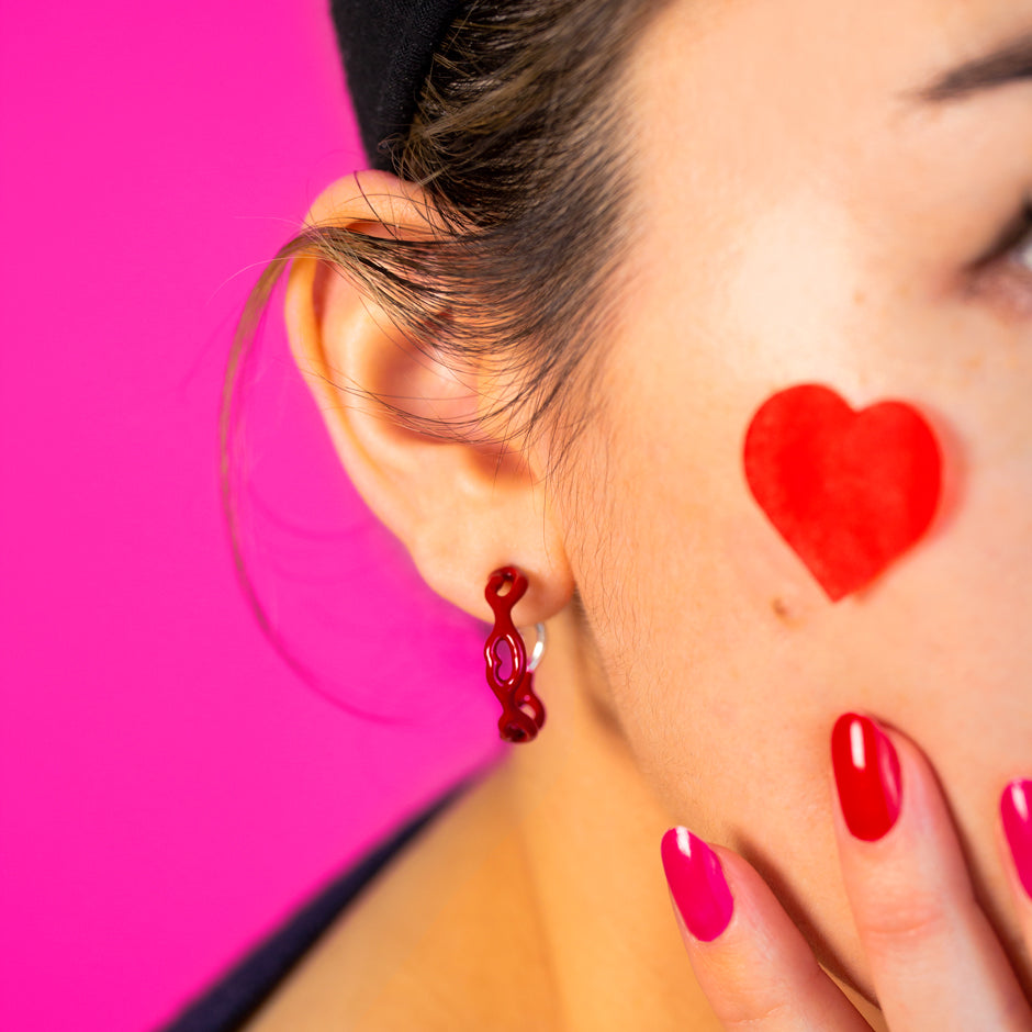 Little Kisses Hoop Earrings red enamel on model heart cheeks