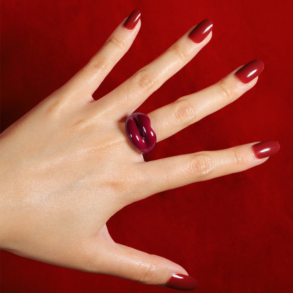 Hotlips by Solange Deep Red Silver and Enamel Lip Shaped Ring By Solange Azagury-Partridge On Models hand with red background