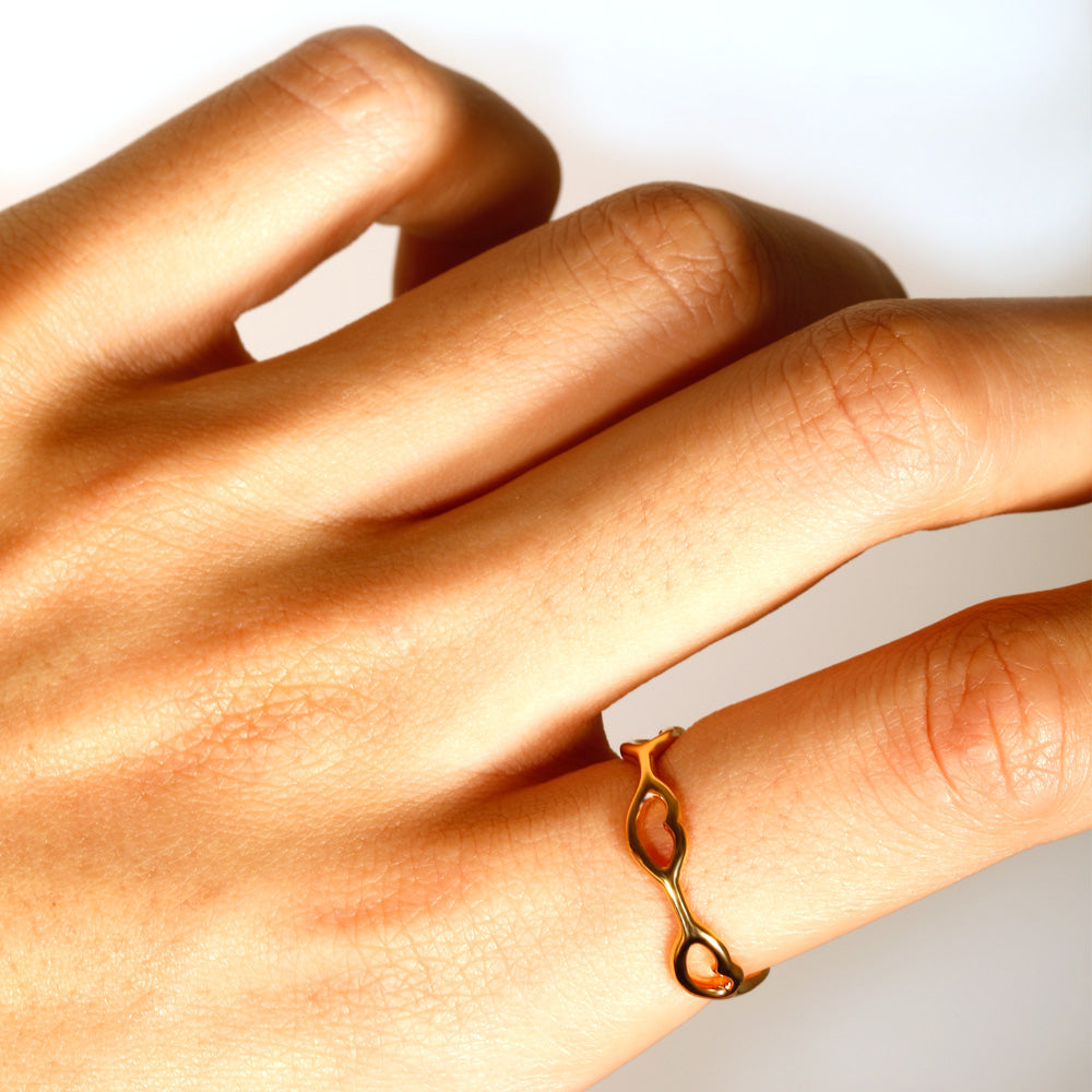 Little Kisses ring in gold by British designer Solange Azagury-Partridge angled view on model