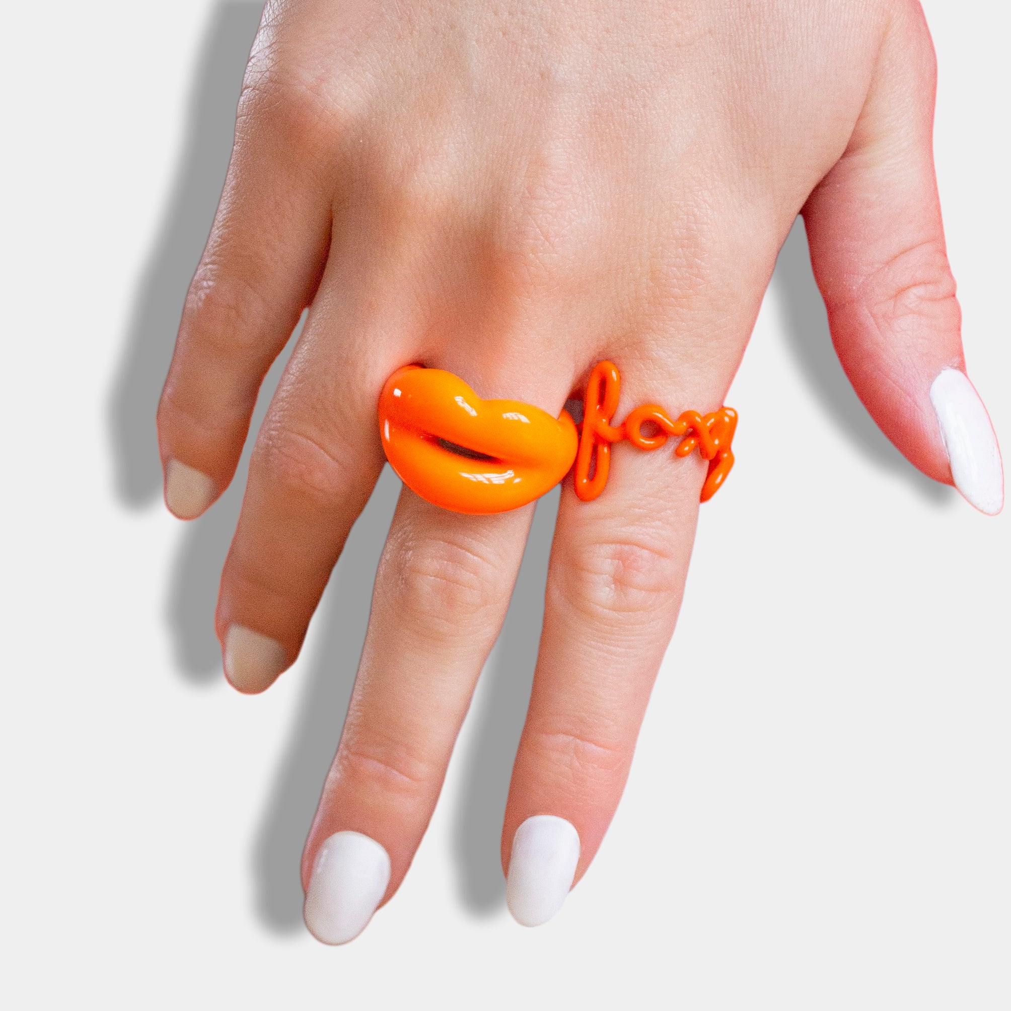 Neon Orange Yellow and Pink Hotlips rings on model hand