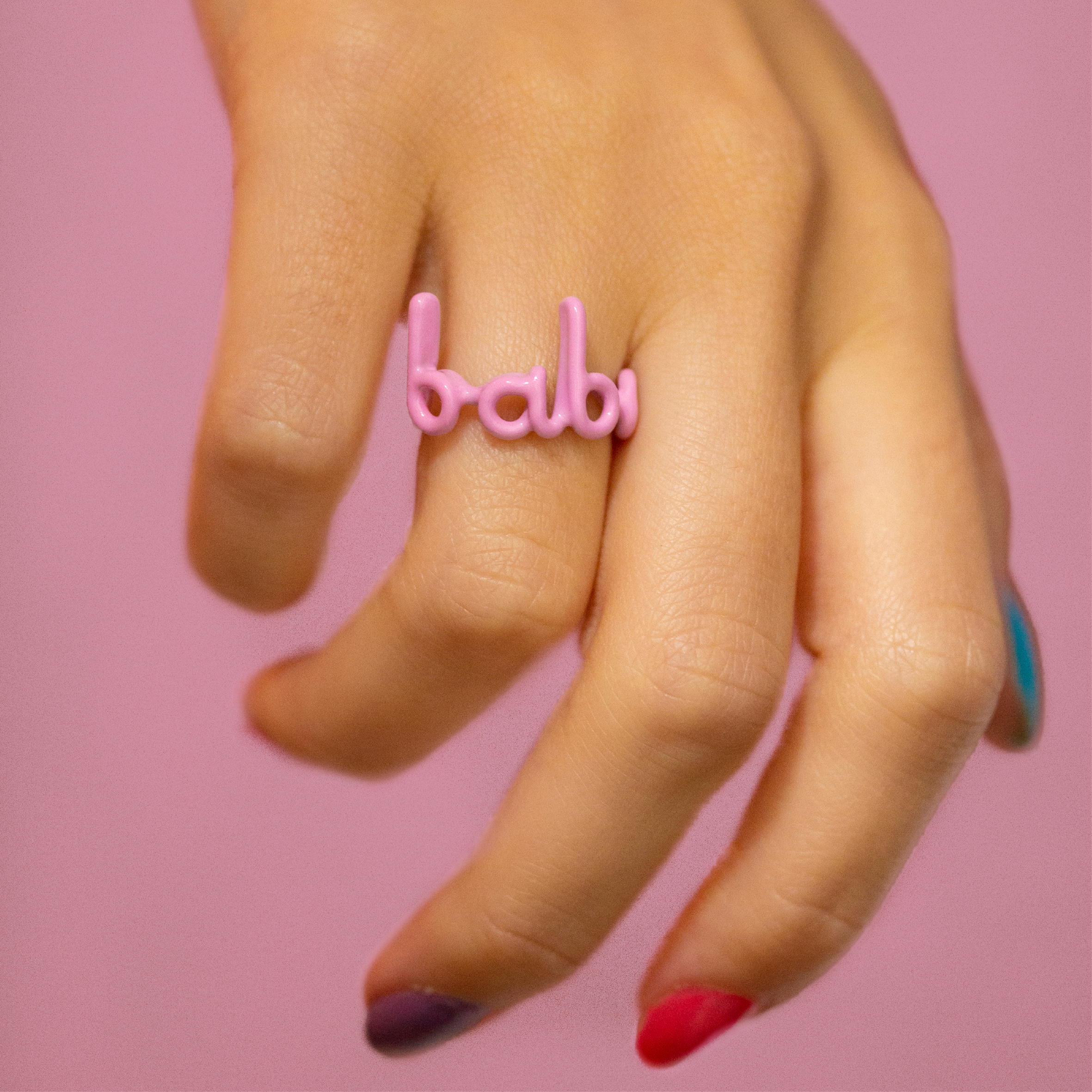 Babe Hotscripts silver and pink enamel ring on hand