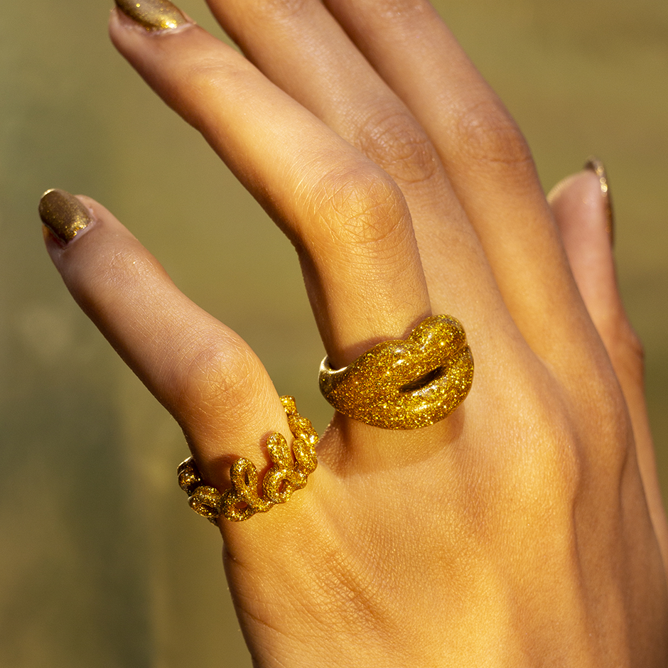 Glitter Gold Goddess enamel word Hotscripts ring and Gold Glitter Hotlips ring on hand