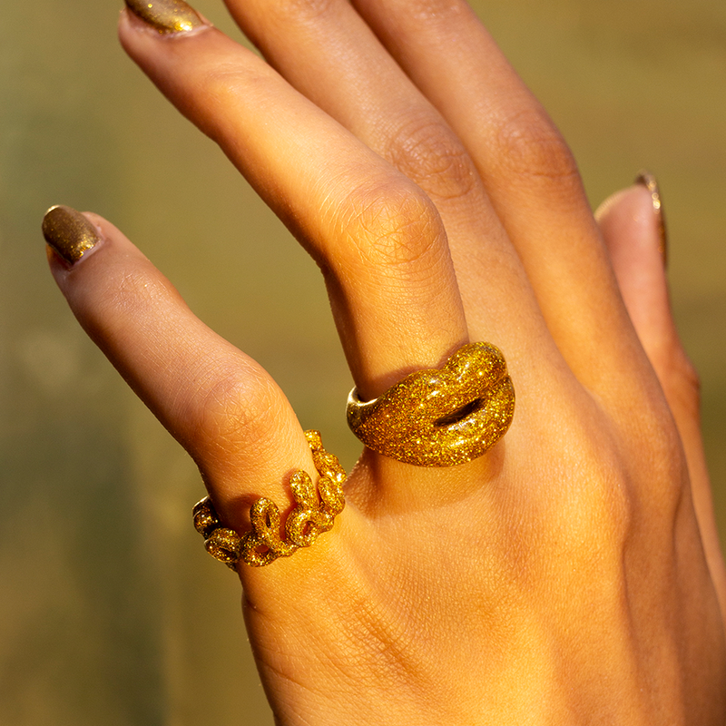 Glitter Gold Goddess enamel word Hotscripts ring and Gold Glitter Hotlips ring on hand