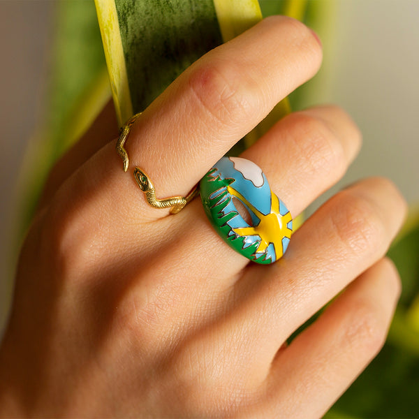 Gatekeeper snake ring and Summer Hotlips by Solange Enamel ring with sun cloud sky and grass on model