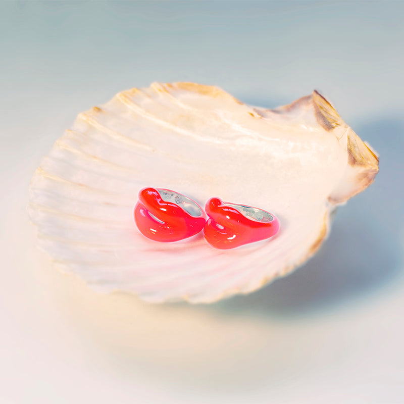 Two Neon Coral Hotlips rings by Solange on scallop shell