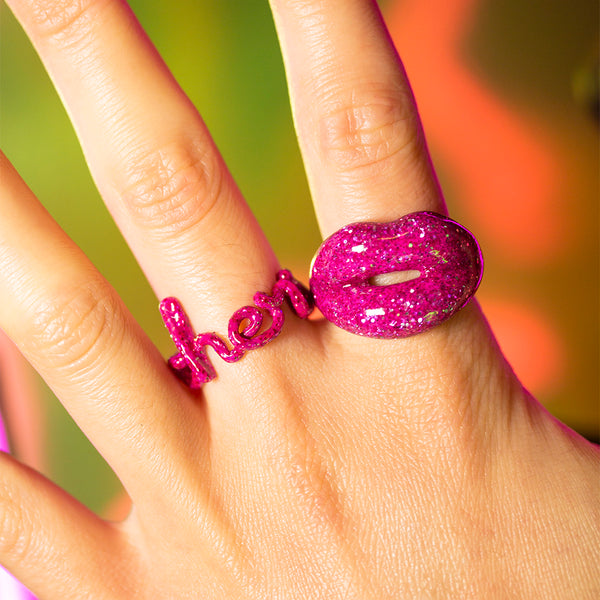 Cherie Hotscripts and Glitter pink Hotlips ring on hand