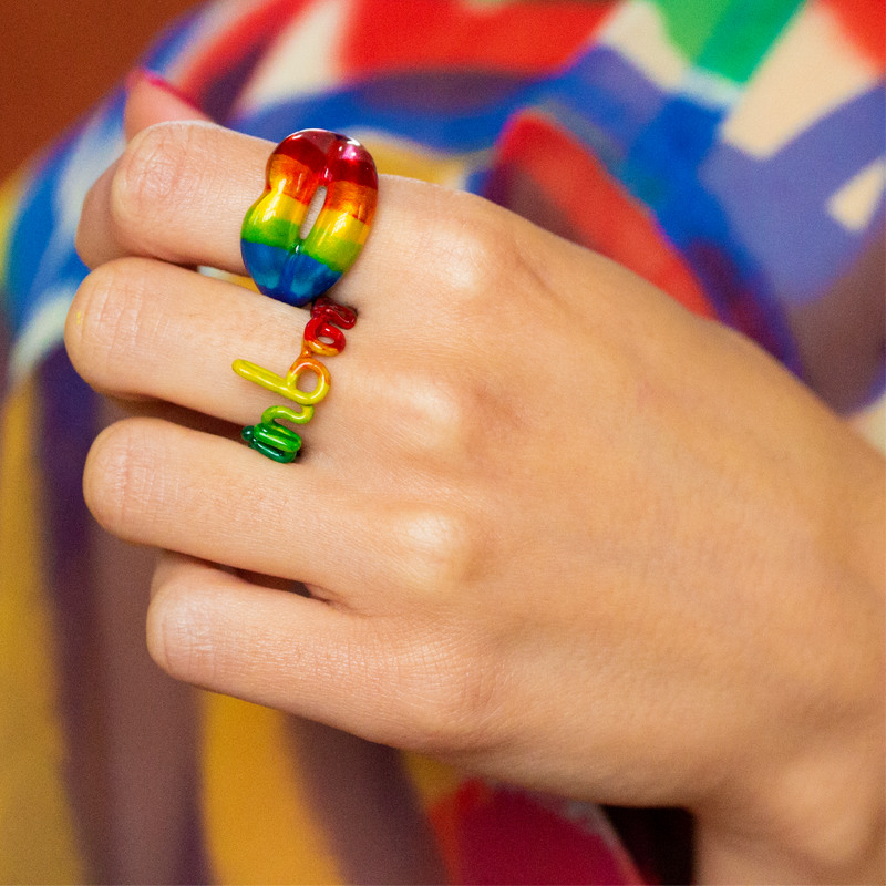 Rainbow Hotscript word ring and rainbow Hotlips ring by Solange on hand