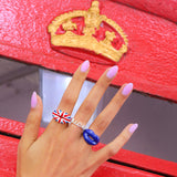 Union Jack Royal Blue Hotlips Enamel & Silver Flag Lip Shaped Rings and Queen Word ring by Solange Azagury-Patridge on hand in front of British telephone box