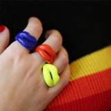 Royal Blue Orange and Neon Yellow Hotlips ring on hand Rainbow sweater