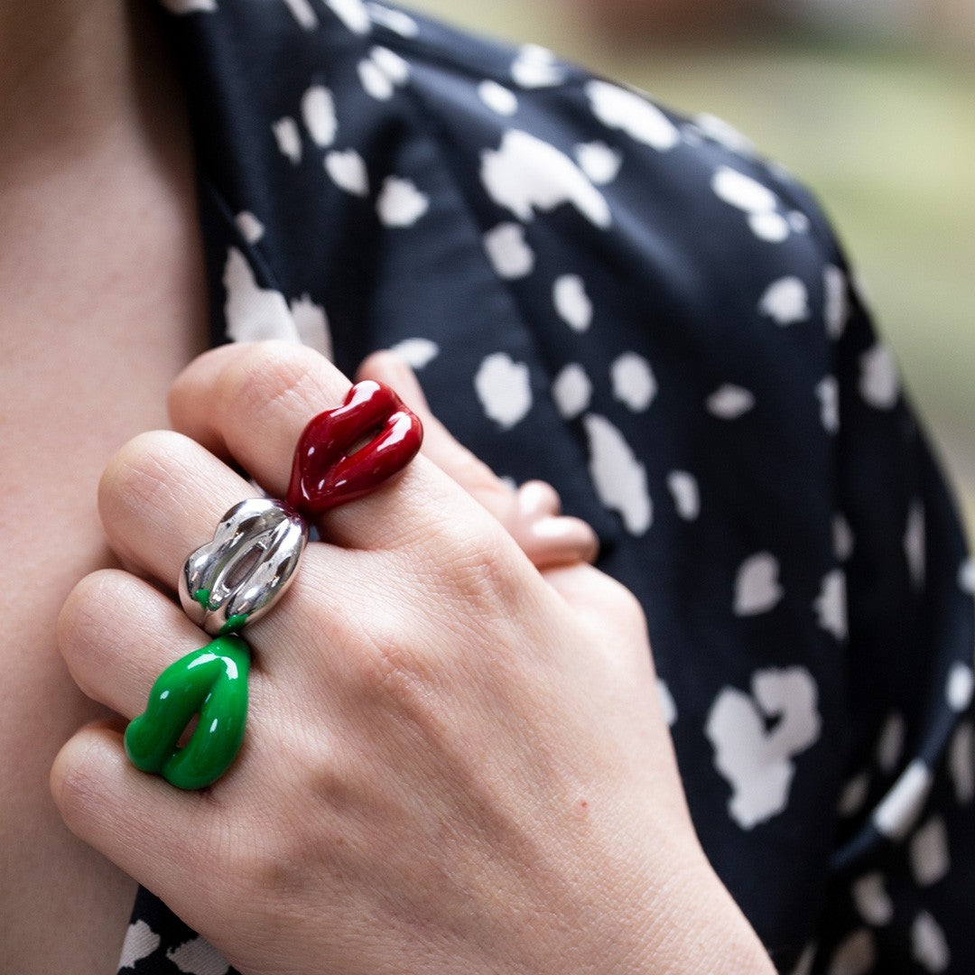 Green silver and classic red Hotlips rings by Solange on hand