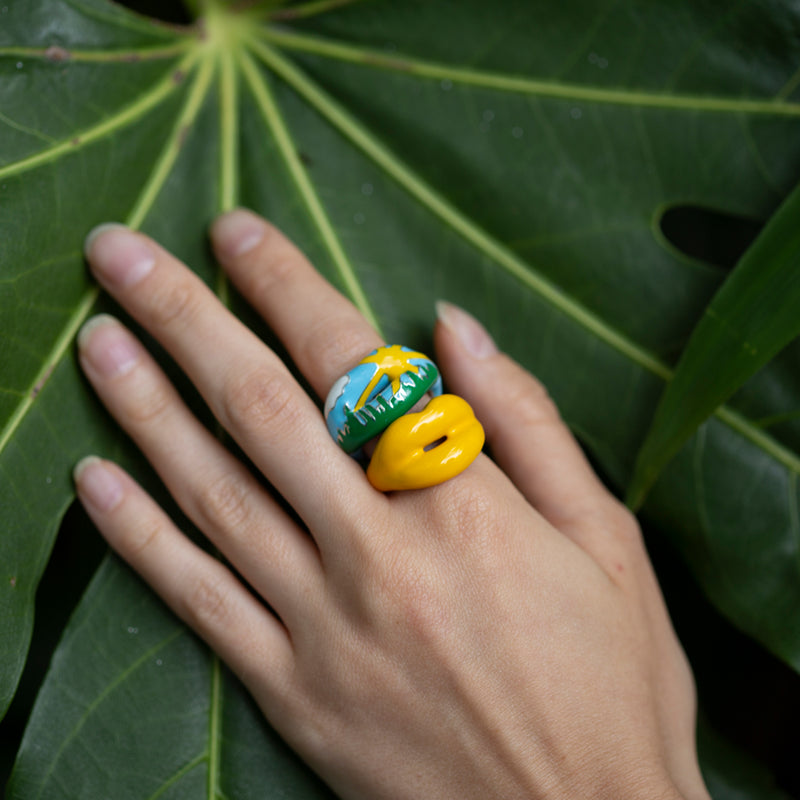 Summer Hotlips by Solange Enamel ring with sun cloud sky and grass on model